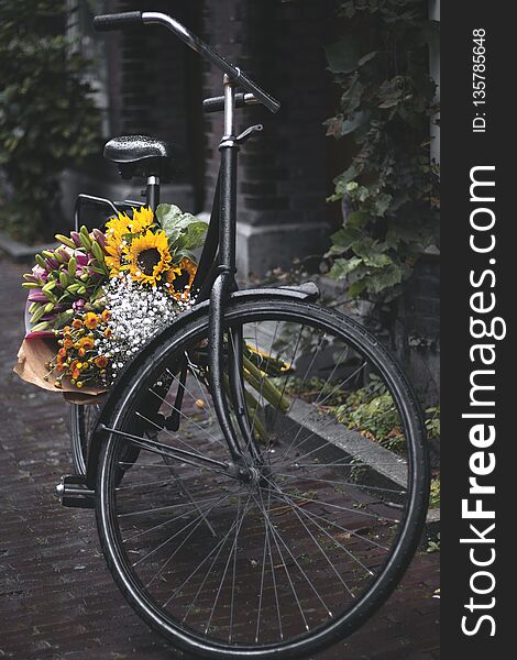 Picture of black bicycle with flowers standing on the street in Amterdam. Picture of black bicycle with flowers standing on the street in Amterdam.