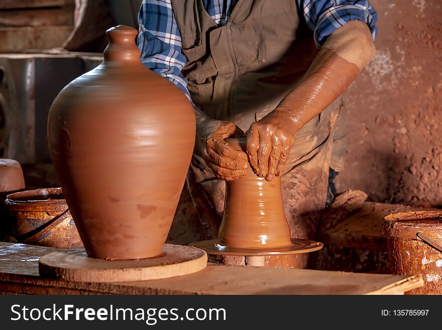 Professional potter making bowl in pottery workshop