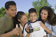 Boy Looking At Camcorder Royalty Free Stock Photography Boy Looking At Camcorder Royalty Free Stock Photography