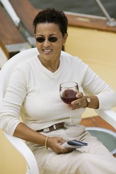 Woman Relaxing On Yacht, Holding Glass Of Wine Stock Image Woman Relaxing On Yacht, Holding Glass Of Wine Stock Image
