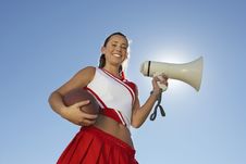 Cheerleader Holding Football And Megaphone Royalty Free Stock Photography Cheerleader Holding Football And Megaphone Royalty Free Stock Photography