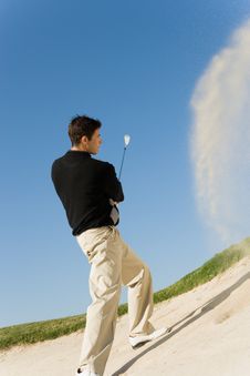 Golfer Hitting Ball Royalty Free Stock Image