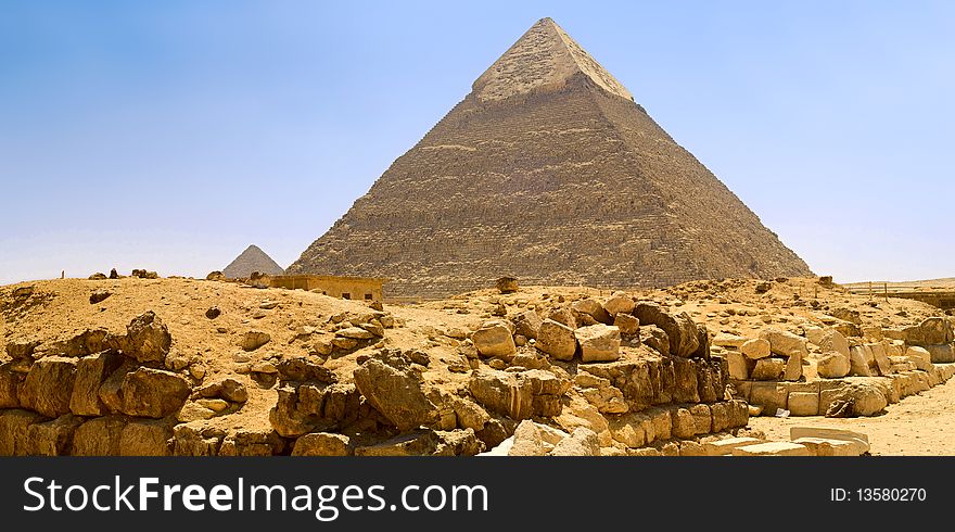 Egyptian pyramid on the background of blue sky