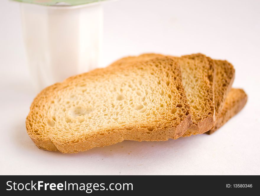 Dry bread with yogurt on a white background