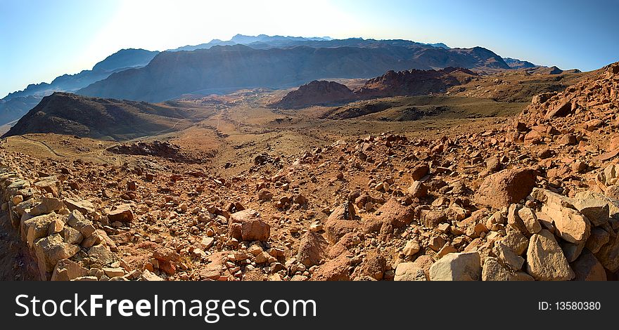 Stone desert with a mountain range in the distance