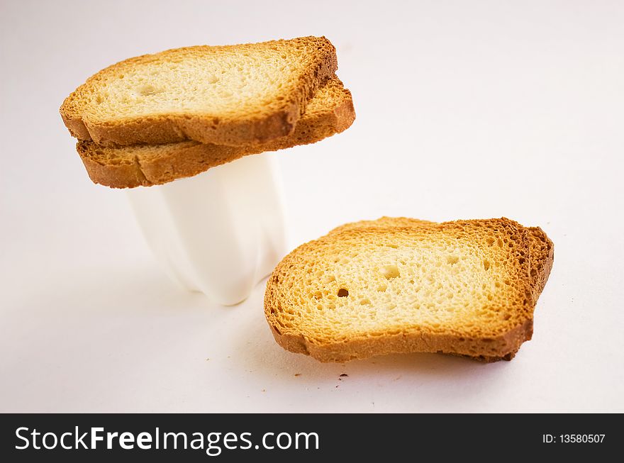 Dry bread with yogurt on a white background