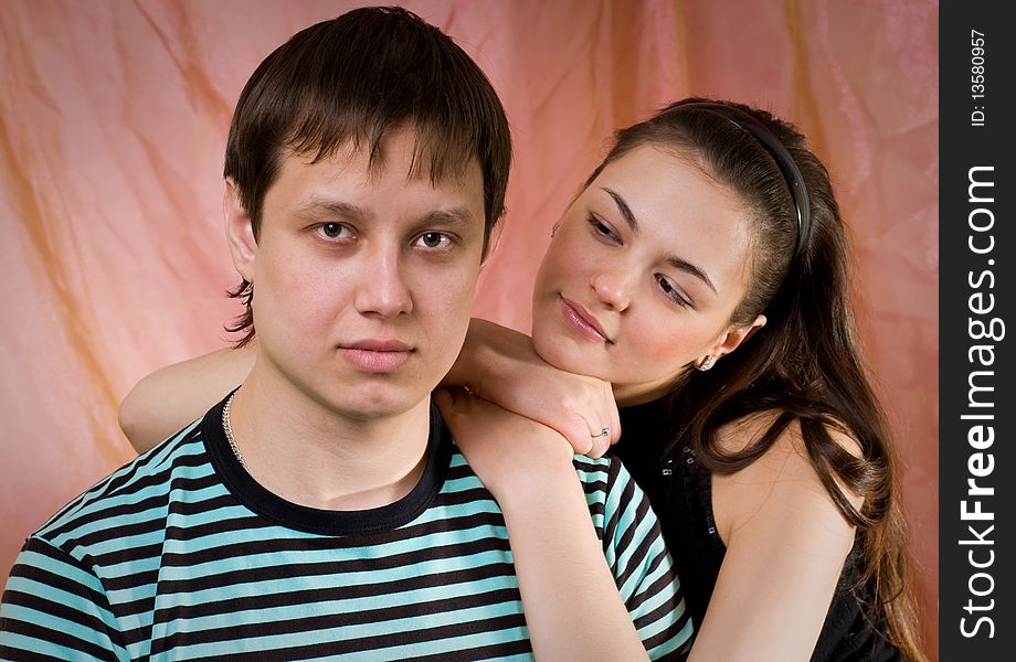 The young couple in a pink background