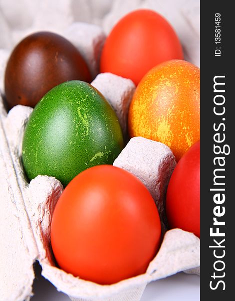 Six Colorful eggs in a carton
