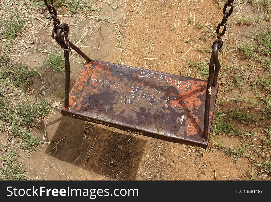 Image of a swing in a playground.