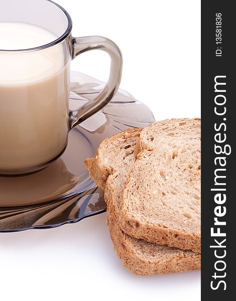 Bread and cup of milk on a white background