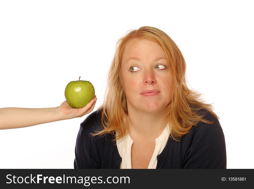 Woman looking at an apple on an isolated background