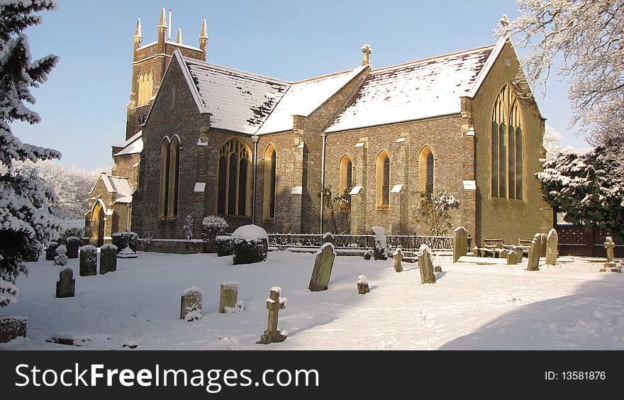 A english church covered in snow. A english church covered in snow