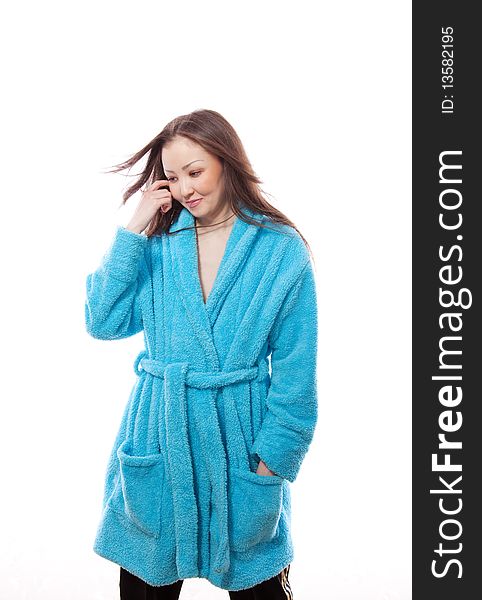 The girl the Asian costs in a dark blue dressing gown on a white background
