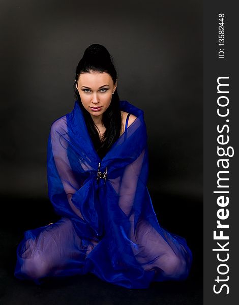 Woman In A Transparent Dark Blue Cape