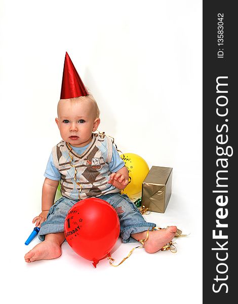 First birthday - happy baby boy with balloons on white background.