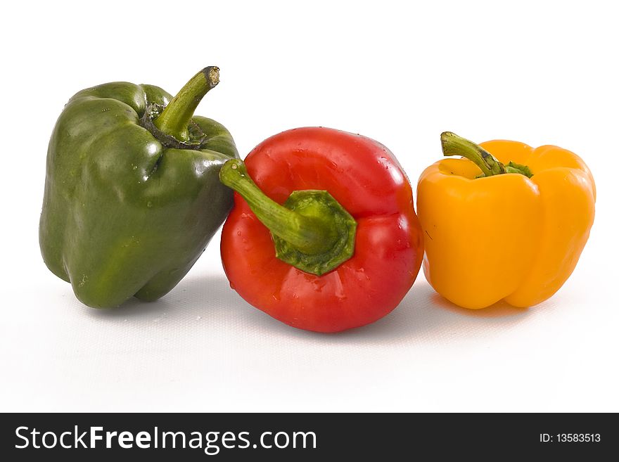 Green Red and Yellow Peppers on white background. Green Red and Yellow Peppers on white background