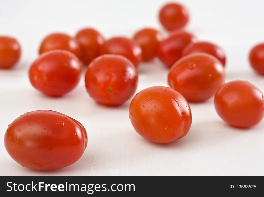 Cherry plum tomatoes on white background. Cherry plum tomatoes on white background