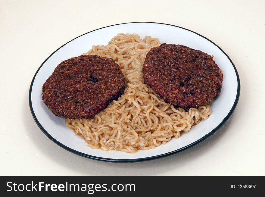 Homemade Burgers and noodles on a plate on a white background. A hamburger is not made of ham but of ground-up beef, shaped into a patty, which is then grilled and placed between the two halves of a sesame seed bun. It takes a lot of cows to provide the world&#x27;s hamburgers, and turning so many cattle into so much beef meat needs an industrial process. The common belief is that the American hamburger borrowed its name from a dish called &#x22;Hamburg Style Beef&#x22; or &#x22;Hamburg Steak&#x22; which arrived in the United States from the German city of Hamburg in the 19th century. The dish was nothing more than chopped meat eaten raw. Bind it. If you&#x27;re going for leaner meat or adding bulky ingredients &#x28;eg spring onions, onions, chillies&#x29;, add an egg and a handful of breadcrumbs to bind the burgers.