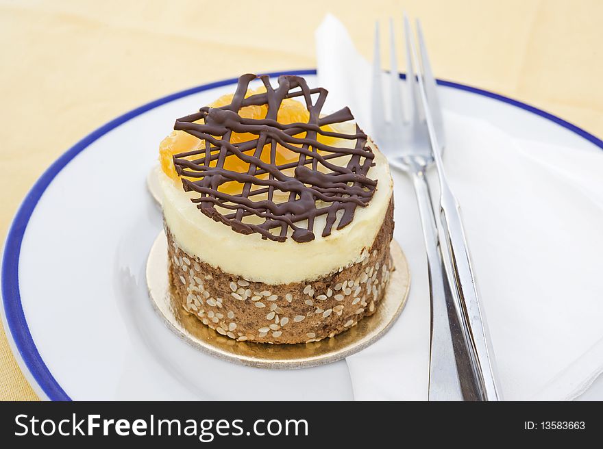 Small fruit cheesecake on a white plate. Small fruit cheesecake on a white plate