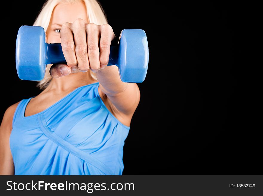 Picture of blond sportswoman holding dumbbells. Picture of blond sportswoman holding dumbbells