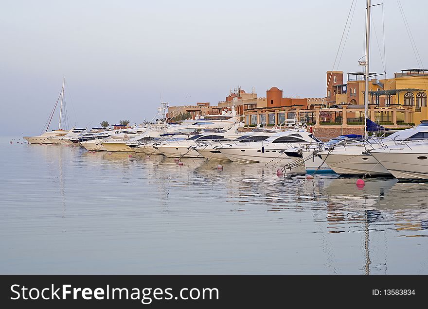 Private motor yachts moored up in a marina. Private motor yachts moored up in a marina