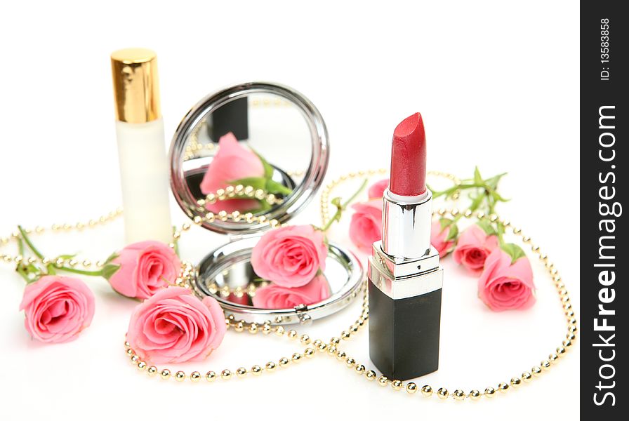 Decorative cosmetics and roses on a white background