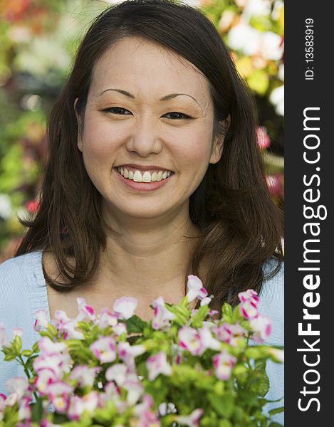 Woman Holding Flowers in plant