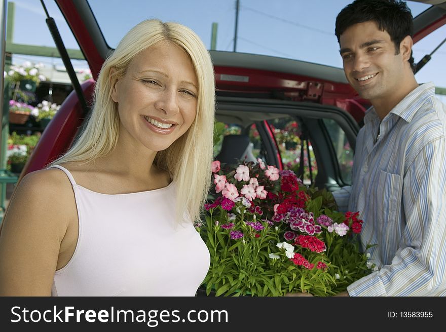 Couple Loading Plants Into Minivan, portrait