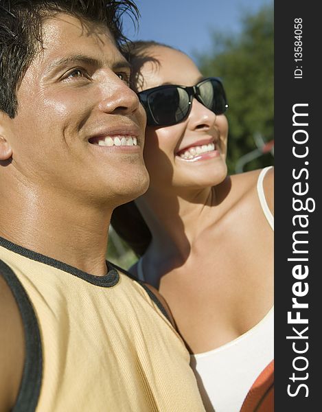 Young Couple outdoors, smiling holding a basketball. Young Couple outdoors, smiling holding a basketball.