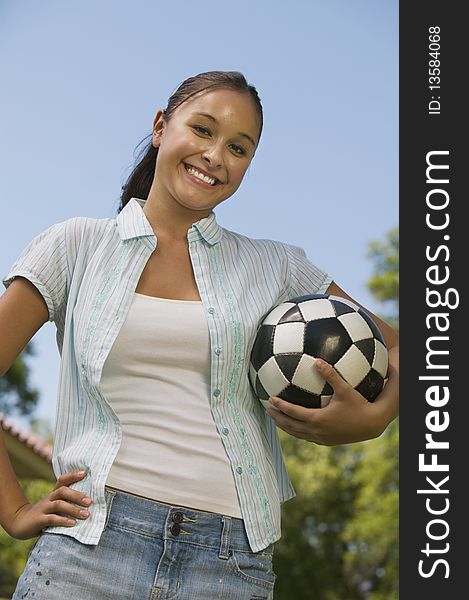 Young Woman Holding Soccer Ball.