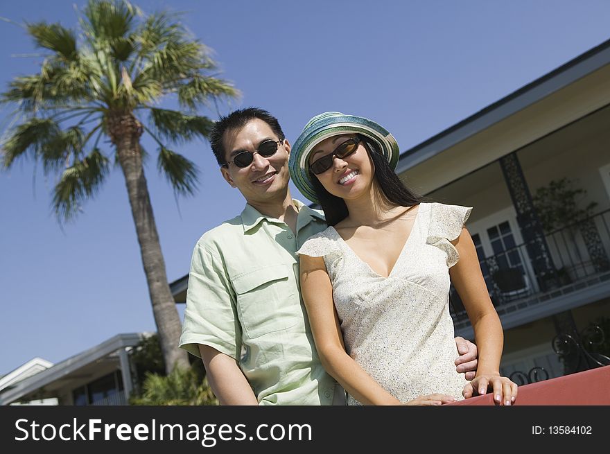 Couple smiling standing outdoors, (portrait)