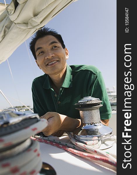 Asian ethnic Man on sailboat