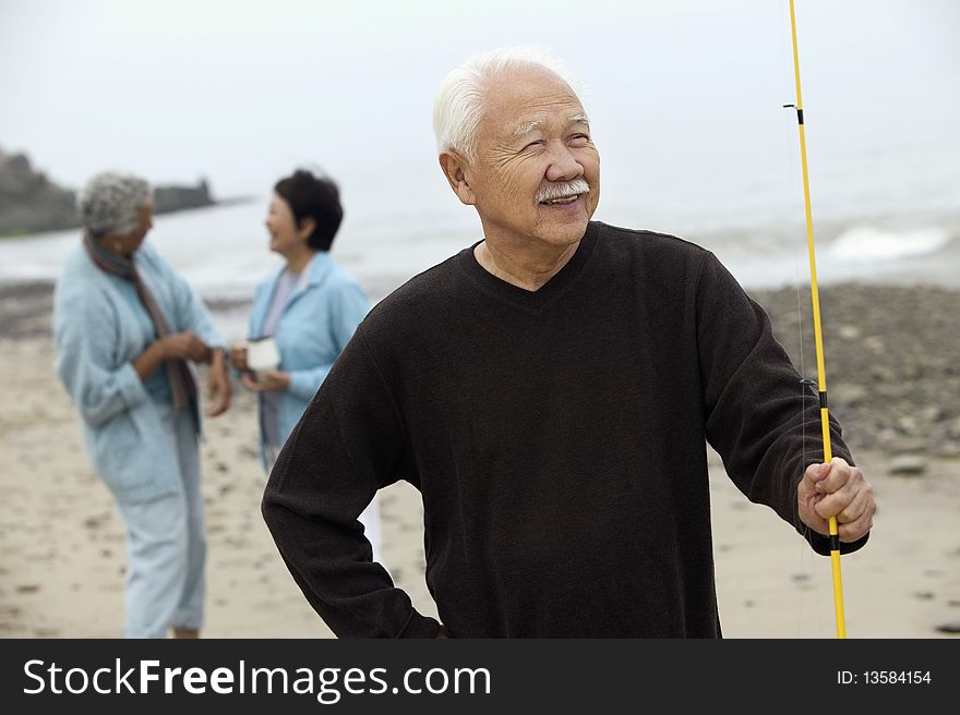 Asian ethnic Fisherman on beach