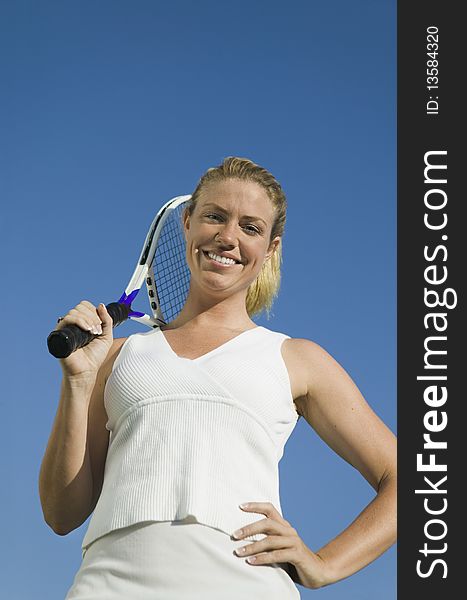 Female tennis player Holding Tennis Racket, portrait, low angle view