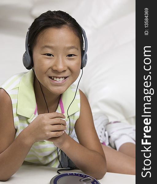 Young Girl on sofa Listening to portable CD player. Young Girl on sofa Listening to portable CD player