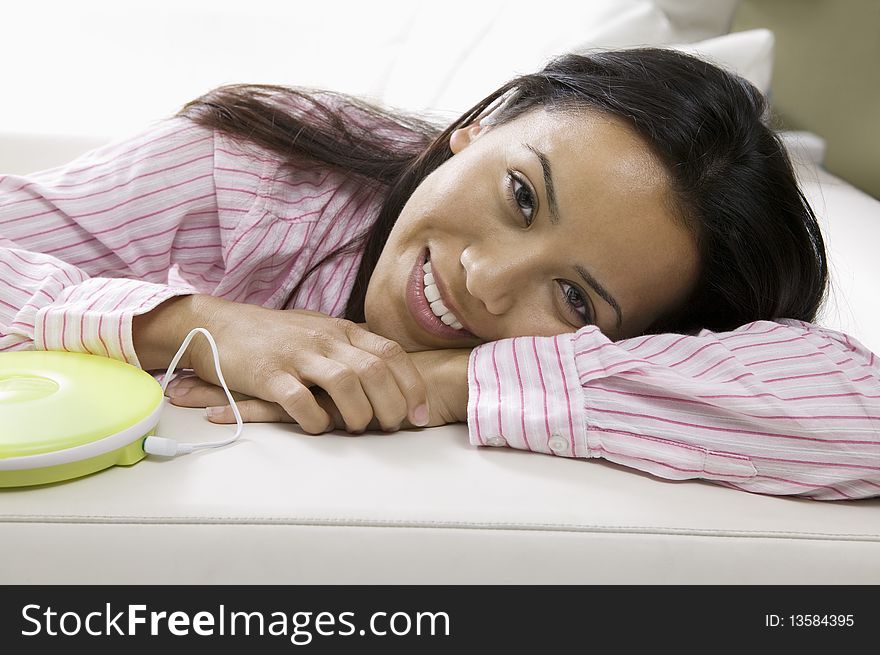 Woman Lying on sofa listening to music