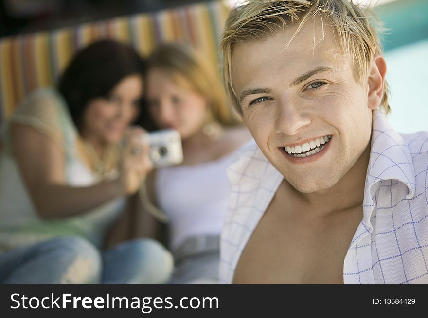 Young Man Sitting On Patio Smiling