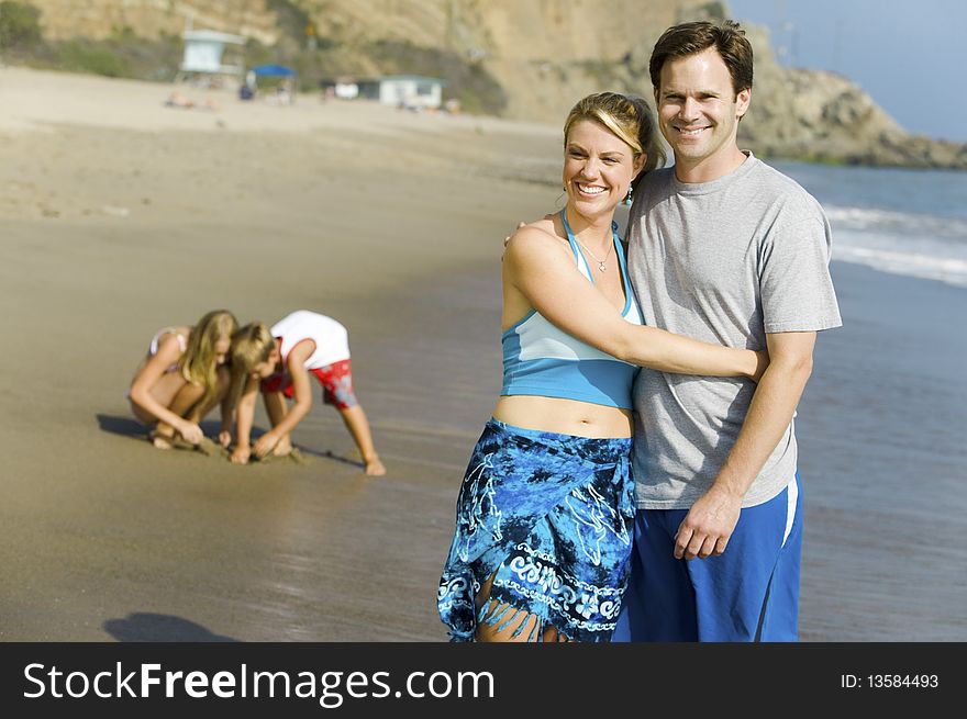 Couple with Family Enjoying relaxing on Beach. Couple with Family Enjoying relaxing on Beach