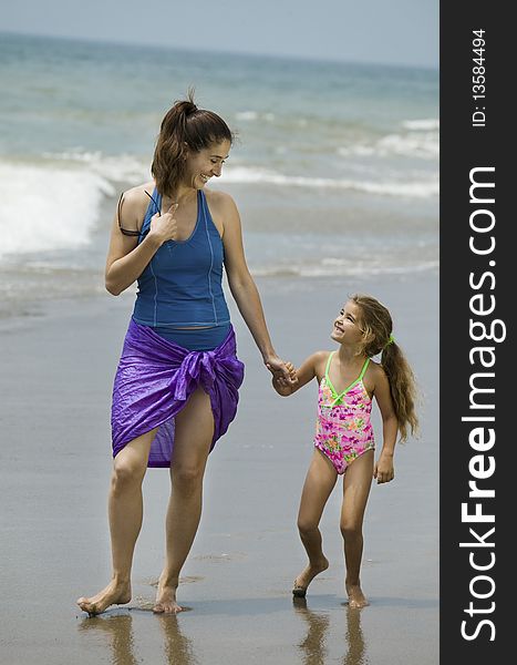 Mother and Daughter walking at the Beach. Mother and Daughter walking at the Beach
