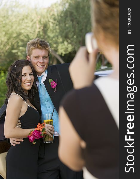 Well-dressed teenagers taking picture outside