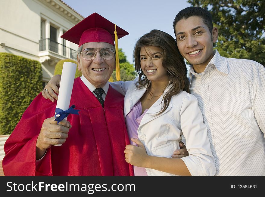 Senior Graduate with son and daughter outside, portrait
