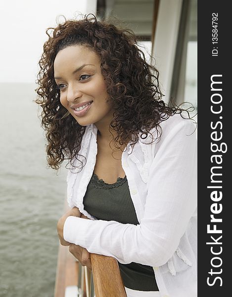 Woman relaxing on yacht, (portrait)