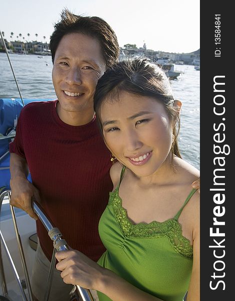 Couple At Helm On Boat