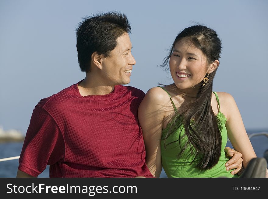 Asian ethnic Couple relaxing on boat