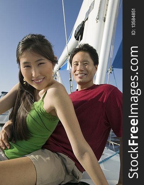 Couple relaxing on boat, (portrait)