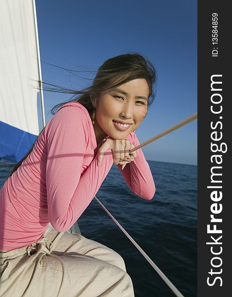 Woman Relaxing On Sailboat