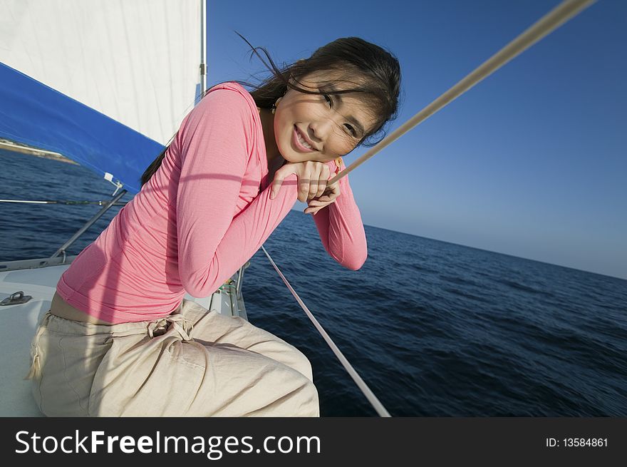 Woman Relaxing On Sailboat