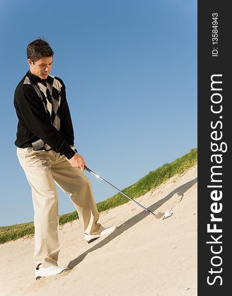 Golfer hitting ball from sand trap