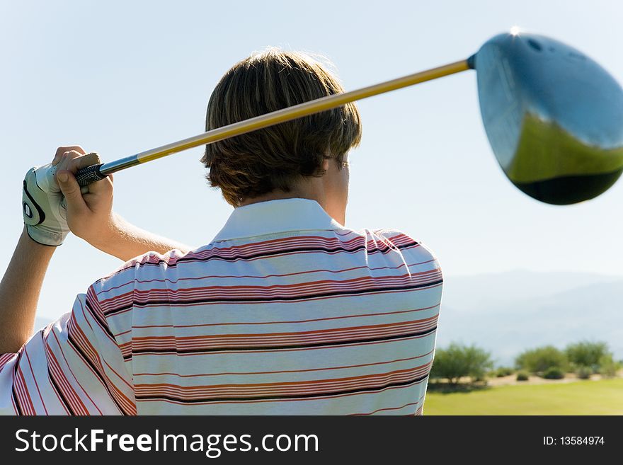 Golfer Swinging Club