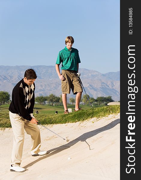 Golfer hitting ball from sand trap